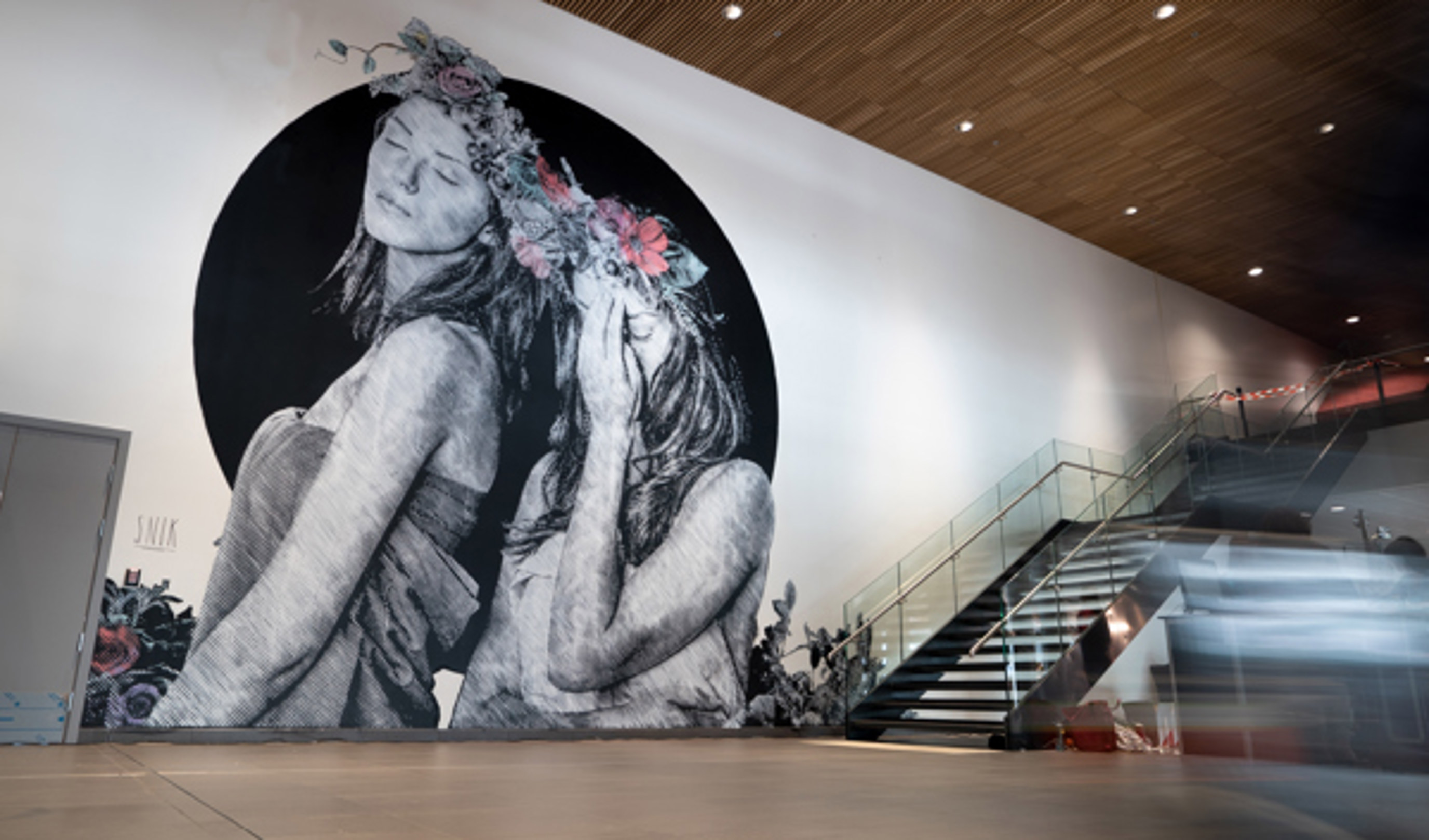 Artwork at Stavanger Airport, painting on a large wall of two ladies